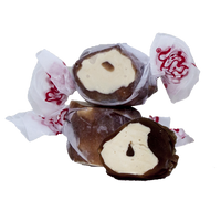 Three pieces of Taffy Town’s Chocolate Caramel Mocha taffy candy show its rich brown swirl and creamy center—gourmet salt water taffy with a melt-in-your-mouth texture.