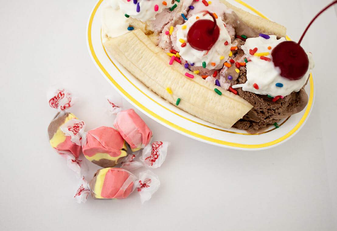 Taffy Town banana split salt water taffy candy next to classic banana split ice cream sundae