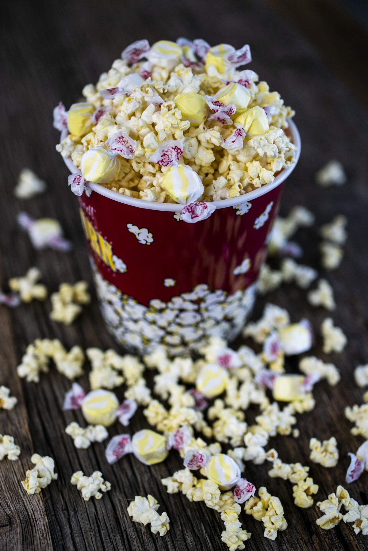 Taffy Town buttered popcorn salt water taffy candy mixed with fresh popcorn in a red movie theater tub